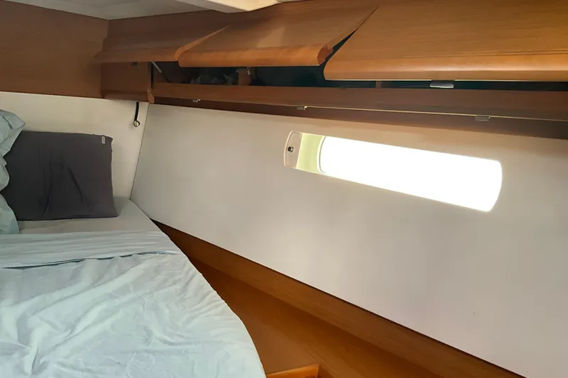 Epicurios Yacht Photos Pics Cozy cabin interior of 2015 Jeanneau Sun Odyssey 469 sailboat with soft lighting.