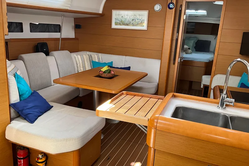 Epicurios Yacht Photos Pics Interior of 2015 Jeanneau Sun Odyssey 469 yacht with cozy seating and modern kitchen.