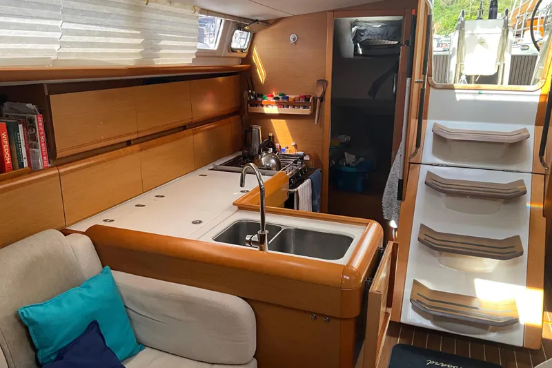 Epicurios Yacht Photos Pics Interior of 2015 Jeanneau Sun Odyssey 469 yacht with modern kitchen and cozy seating area.