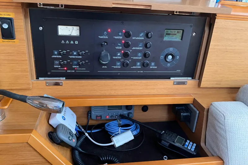 Epicurios Yacht Photos Pics Control panel of a 2015 Jeanneau Sun Odyssey 469 sailboat, featuring navigation and communication equipment.