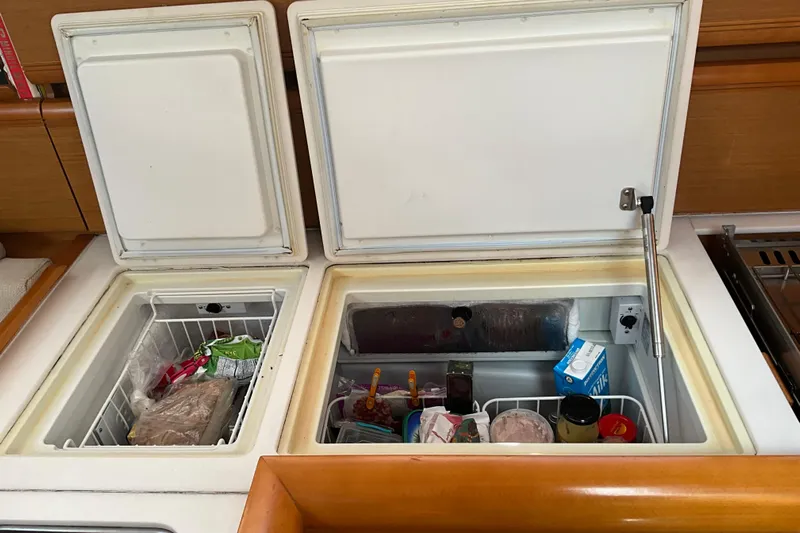 Epicurios Yacht Photos Pics Open fridge compartments on 2015 Jeanneau Sun Odyssey 469 yacht, storing various food items.