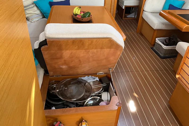 Epicurios Yacht Photos Pics Interior of 2015 Jeanneau Sun Odyssey 469 yacht with open storage and fruit bowl.
