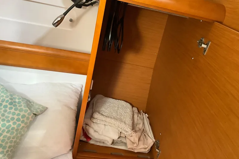 Epicurios Yacht Photos Pics Interior cabin storage on 2015 Jeanneau Sun Odyssey 469 sailboat, with folded linens.