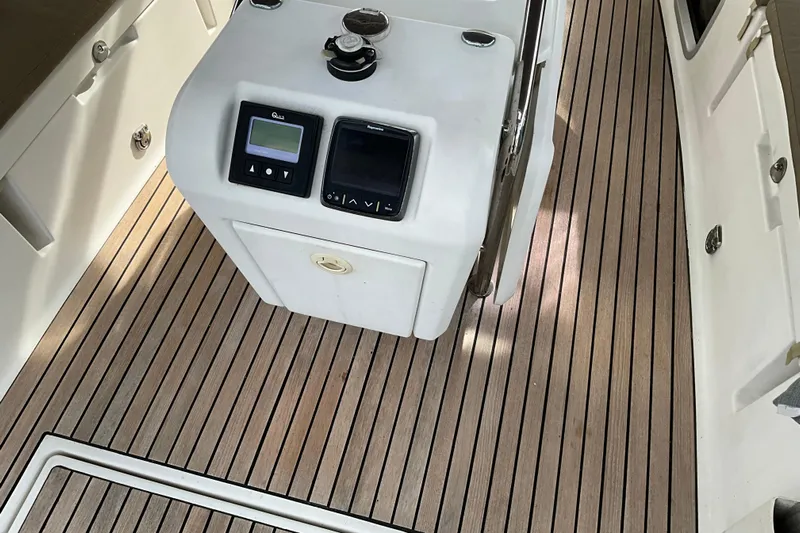 Epicurios Yacht Photos Pics Cockpit of 2015 Jeanneau Sun Odyssey 469 with teak flooring and control panel.