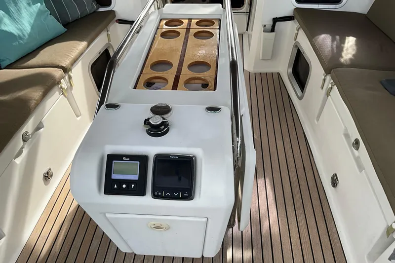 Epicurios Yacht Photos Pics 2015 Jeanneau Sun Odyssey 469 cockpit with control panel and cushioned seating.