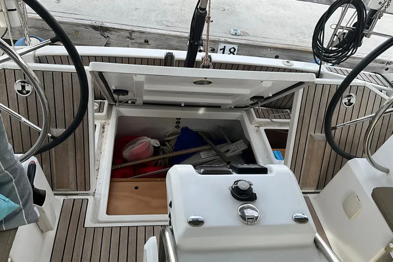 Epicurios Yacht Photos Pics 2015 Jeanneau Sun Odyssey 469 cockpit with open storage compartment and steering wheels.