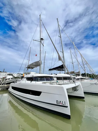 Tropicat Yacht Photos Pics 2024 Bali Catspace 40 catamaran docked in a marina under a partly cloudy sky.