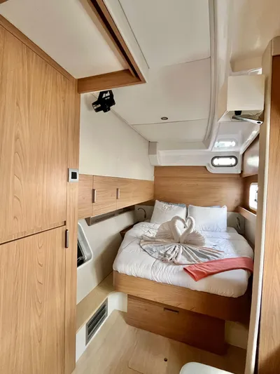 Tropicat Yacht Photos Pics 2024 Bali Catspace 40 cabin with cozy bed and wooden interior design.