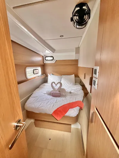 Tropicat Yacht Photos Pics Cozy cabin interior of 2024 Bali Catspace 40 with bed and decorative towel.