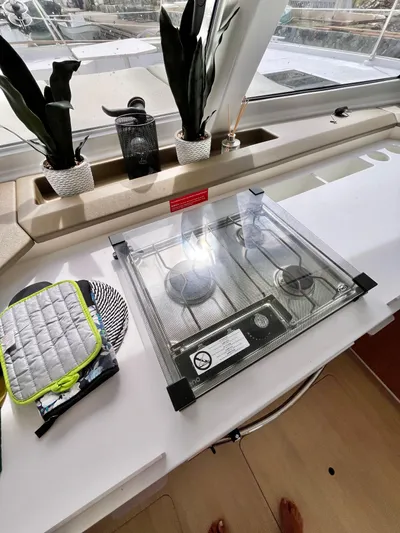 Tropicat Yacht Photos Pics 2024 Bali Catspace 40 yacht interior with stove, plants, and kitchen accessories.