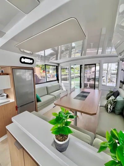 Tropicat Yacht Photos Pics 2024 Bali Catspace 40 interior with modern design, spacious seating, and potted plant.