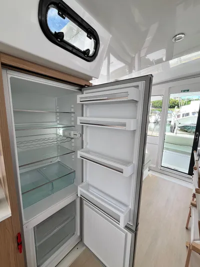 Tropicat Yacht Photos Pics Open refrigerator inside 2024 Bali Catspace 40 catamaran, showcasing spacious interior and modern design.