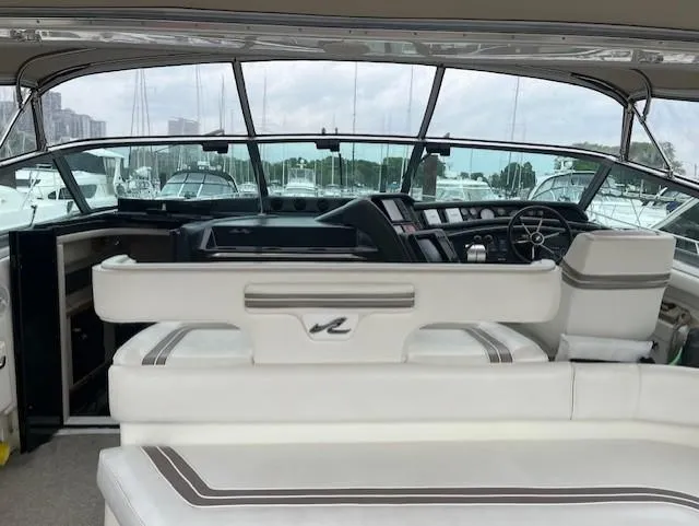 To Come Yacht Photos Pics 1992 Sea Ray Sundancer boat interior with white seating and control panel.