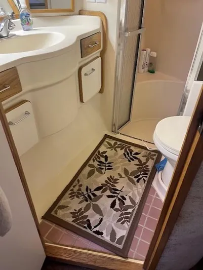 To Come Yacht Photos Pics 1992 Sea Ray Sundancer bathroom with sink, shower, toilet, and floral rug.