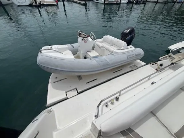 To Come Yacht Photos Pics 1992 Sea Ray Sundancer with inflatable dinghy at marina.