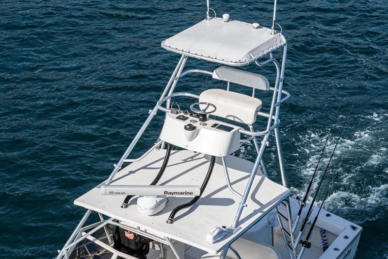 Jesse Girl Yacht Photos Pics 2005 Carolina Classic 28 boat with elevated helm station on open water.