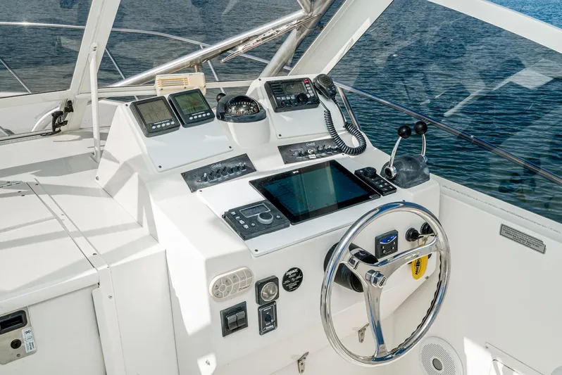 Jesse Girl Yacht Photos Pics 2005 Carolina Classic 28 boat dashboard with navigation instruments and steering wheel.