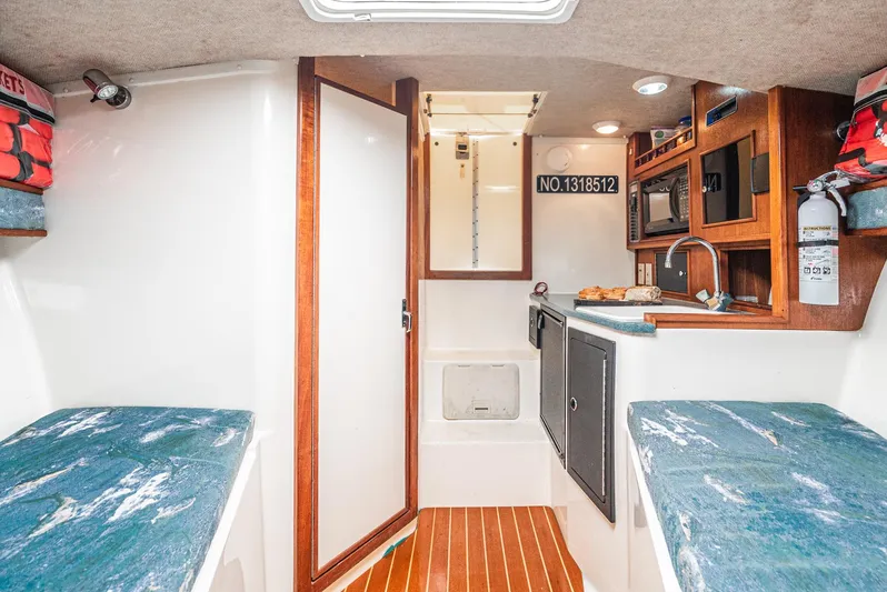 Jesse Girl Yacht Photos Pics Interior of 2005 Carolina Classic 28 boat with kitchenette and seating area.