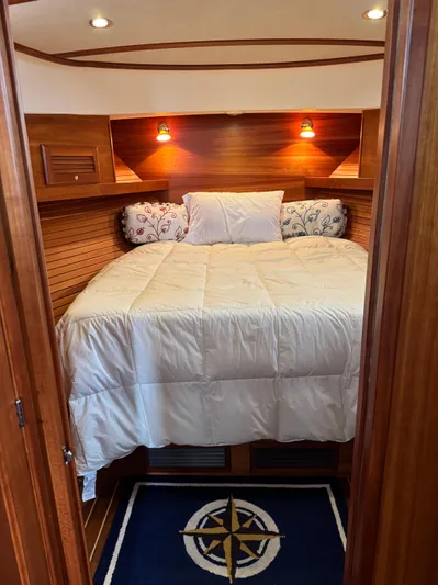  Yacht Photos Pics Cozy bedroom in 2010 Sabre 40 Sedan yacht with wood paneling and nautical decor.
