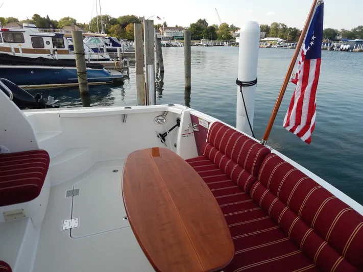  Yacht Photos Pics 2010 Sabre 40 Sedan yacht with striped seating and American flag at marina.