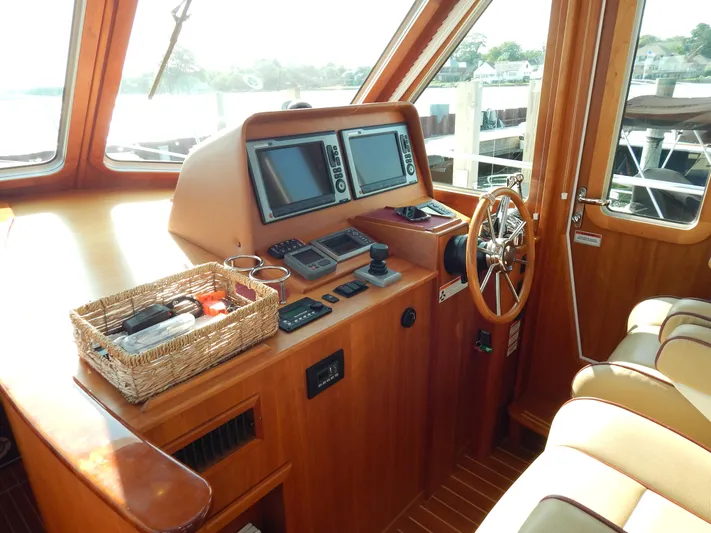  Yacht Photos Pics 2010 Sabre 40 Sedan helm with navigation equipment and wooden steering wheel.