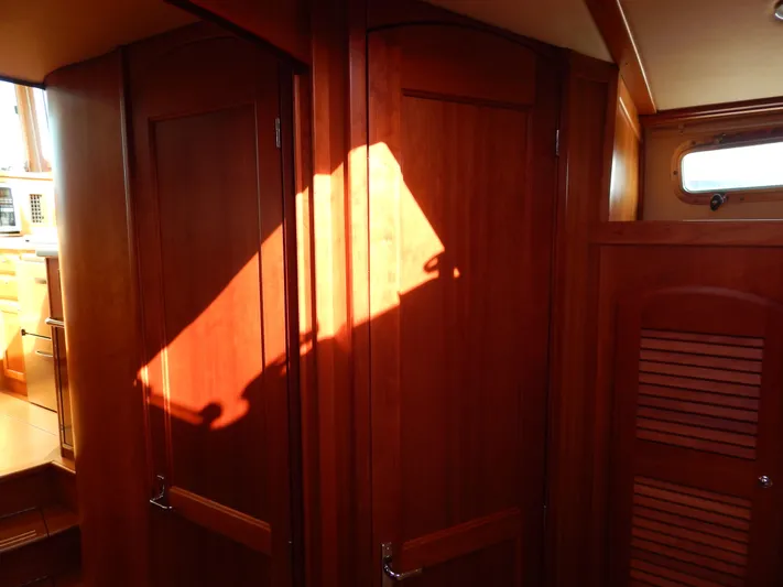  Yacht Photos Pics Interior of 2010 Sabre 40 Sedan with wooden cabinetry and sunlight streaming through a window.