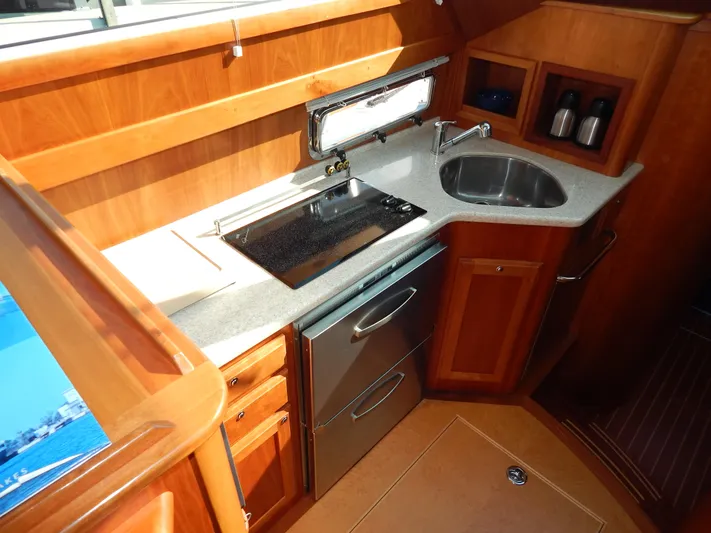  Yacht Photos Pics Luxurious 2010 Sabre 40 Sedan yacht kitchen with modern appliances and wooden cabinetry.