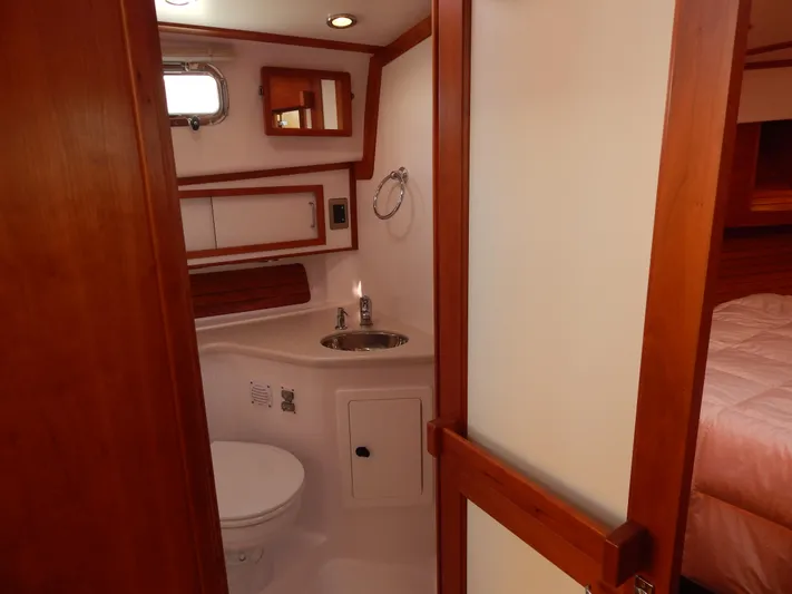 Yacht Photos Pics 2010 Sabre 40 Sedan yacht bathroom with wooden accents and compact design.