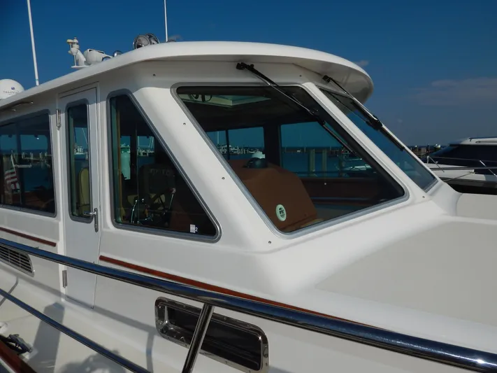  Yacht Photos Pics 2010 Sabre 40 Sedan yacht with sleek design and large windows at a marina.