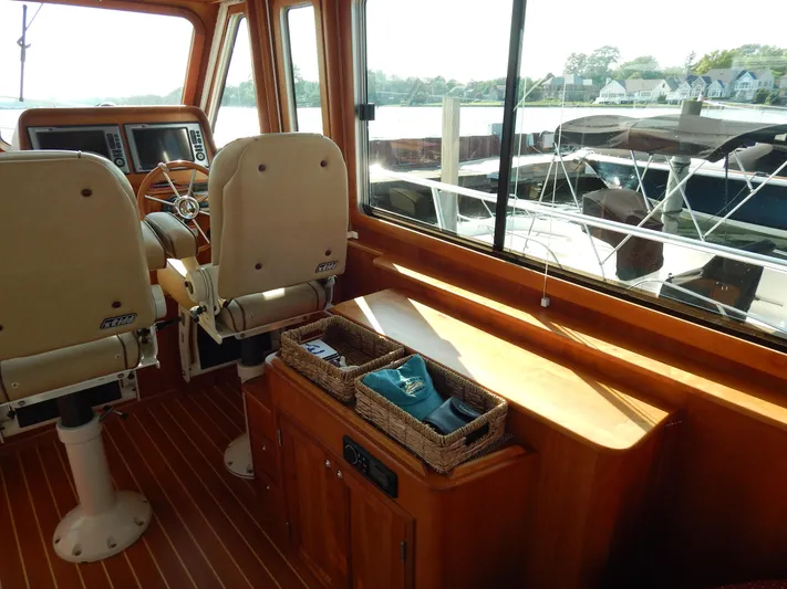  Yacht Photos Pics Interior of 2010 Sabre 40 Sedan yacht with helm seats and wooden cabinetry.