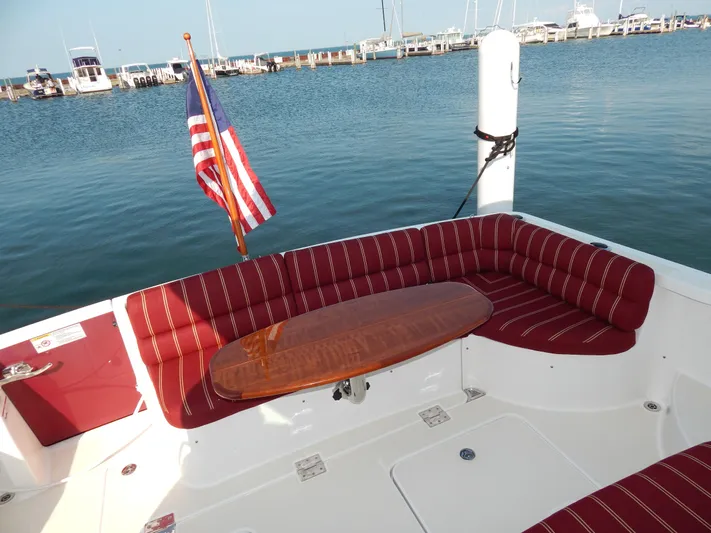  Yacht Photos Pics 2010 Sabre 40 Sedan yacht with red seating, wooden table, and American flag at marina.