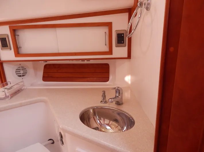  Yacht Photos Pics 2010 Sabre 40 Sedan yacht bathroom with sink, wooden accents, and modern fixtures.