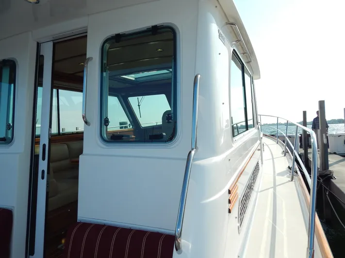  Yacht Photos Pics 2010 Sabre 40 Sedan yacht exterior with windows and railing, docked by the water.