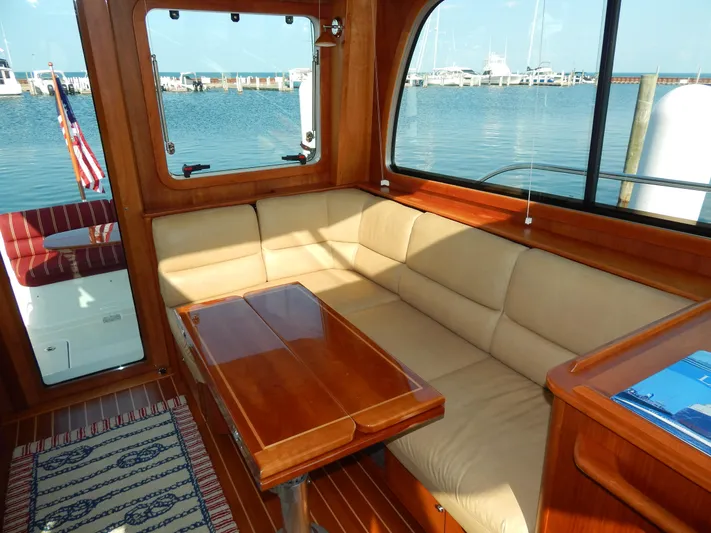  Yacht Photos Pics Luxurious interior of 2010 Sabre 40 Sedan yacht with beige seating and wooden table.