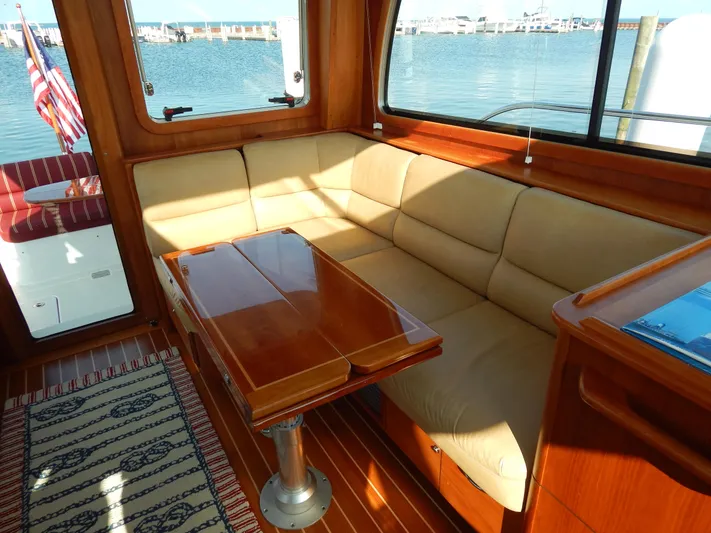  Yacht Photos Pics Luxurious interior of 2010 Sabre 40 Sedan yacht with beige seating and wooden table.