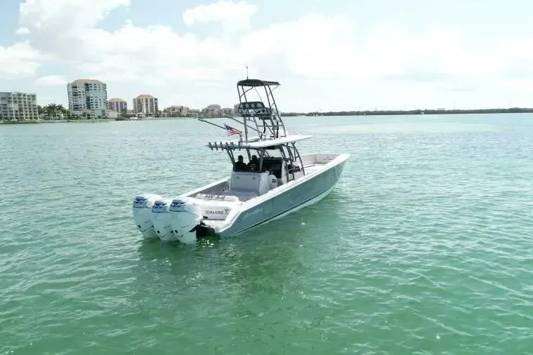  Yacht Photos Pics 2020 Nor-Tech 390 boat on calm water with cityscape in background.