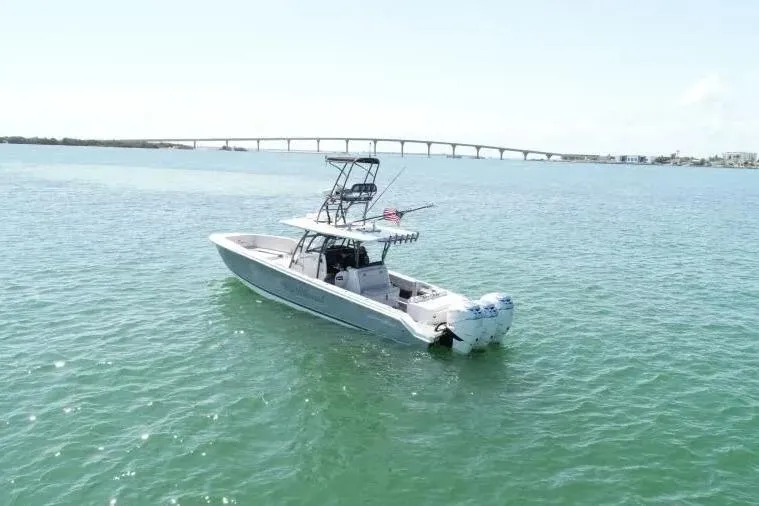 Yacht Photos Pics 2020 Nor-Tech 390 boat on calm water with bridge in background.