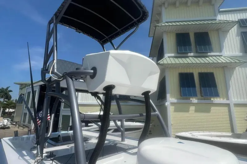  Yacht Photos Pics 2020 Nor-Tech 390 boat with elevated helm station, docked near a building.