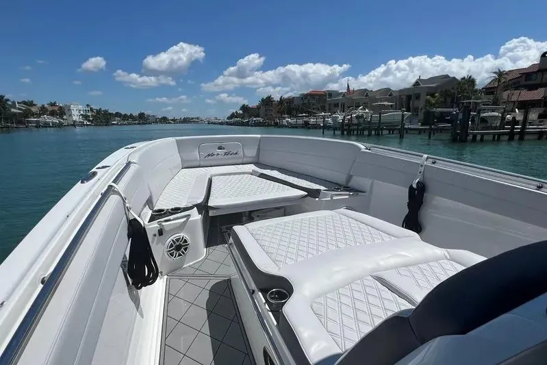  Yacht Photos Pics 2020 Nor-Tech 390 boat with luxurious seating on a sunny waterfront.