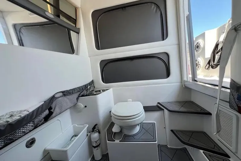  Yacht Photos Pics 2020 Nor-Tech 390 boat interior with toilet, storage, and steps.