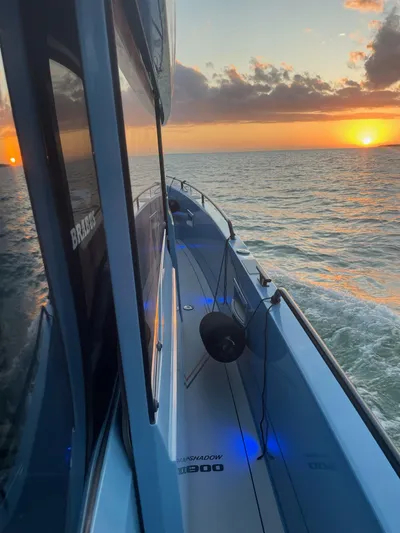  Yacht Photos Pics 2022 Axopar Brabus Shadow 900 XC cruising at sunset on open water.