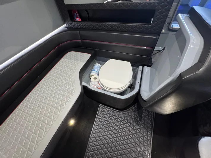  Yacht Photos Pics Luxurious interior of 2022 Axopar Brabus Shadow 900 XC with seating and toilet.