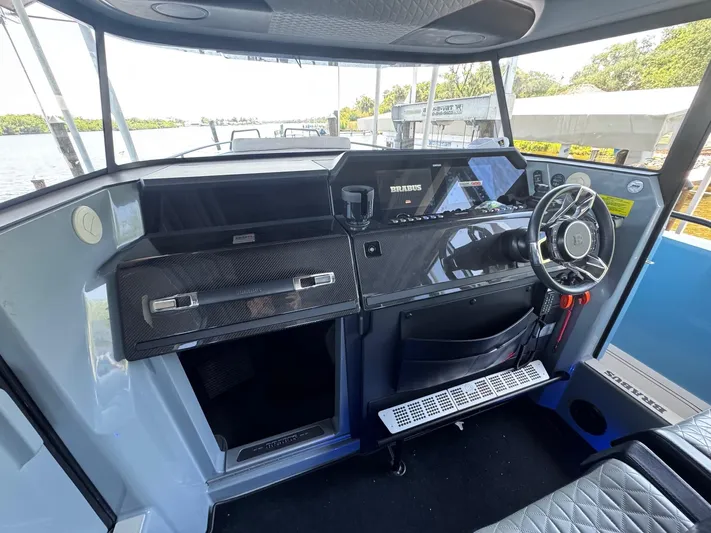  Yacht Photos Pics Cockpit of 2022 Axopar Brabus Shadow 900 XC with modern controls and steering wheel.