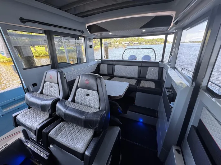  Yacht Photos Pics Interior of 2022 Axopar Brabus Shadow 900 XC boat with luxury seating and scenic water view.