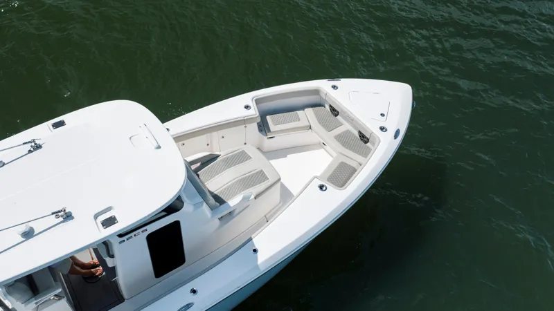  Yacht Photos Pics 2024 Solace 32 CS boat with spacious seating, cruising on calm water.