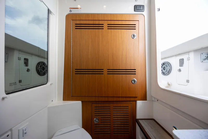  Yacht Photos Pics 2024 Solace 32 CS boat interior with wooden cabinet and window view.