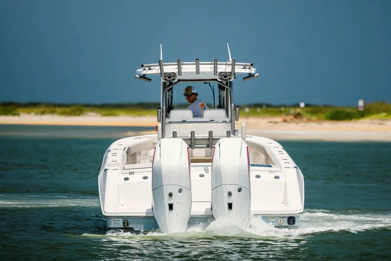 Yacht Photos Pics 2024 Solace 32 CS boat cruising on open water near a sandy shoreline.