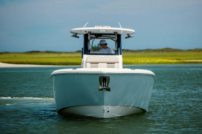  Yacht Photos Pics 2024 Solace 32 CS boat cruising on calm water with scenic background.