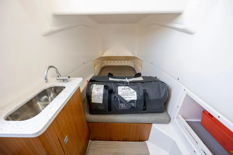  Yacht Photos Pics 2024 Solace 32 CS cabin interior with sink and storage bag.