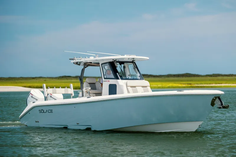  Yacht Photos Pics 2024 Solace 32 CS boat cruising on calm water under a clear blue sky.